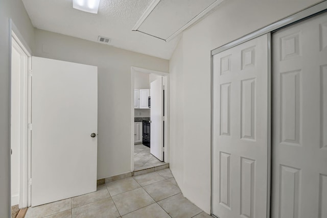 hallway featuring light tile patterned flooring