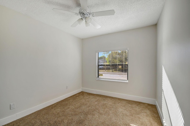 spare room with light carpet, a textured ceiling, and ceiling fan