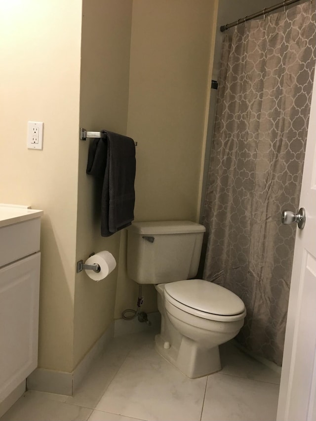 bathroom with a shower with curtain, vanity, toilet, and tile patterned flooring