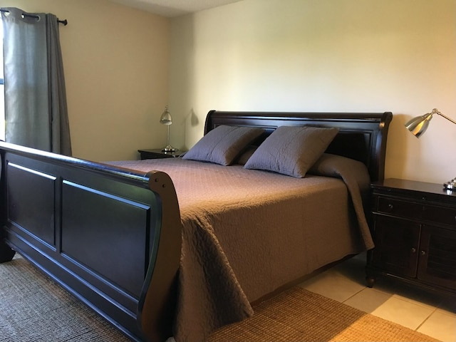 bedroom with light tile patterned floors