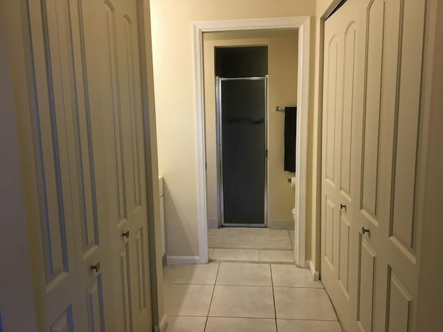 corridor featuring light tile patterned floors