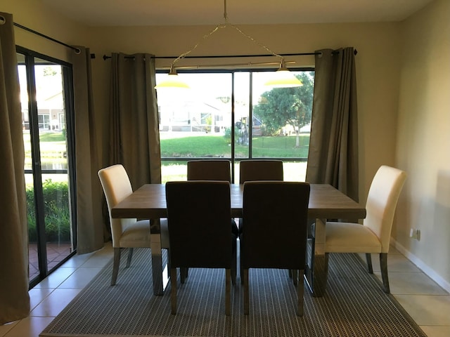 dining space featuring light tile patterned flooring