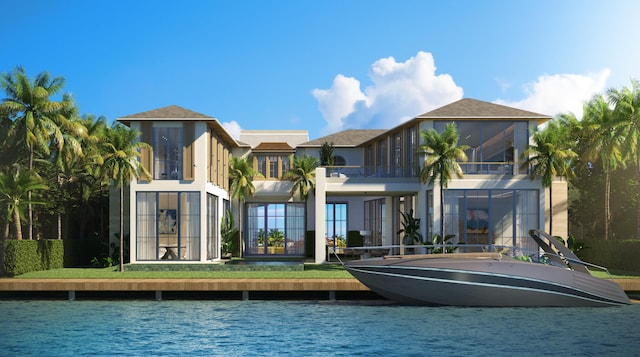 back of property with a water view, stucco siding, and a balcony