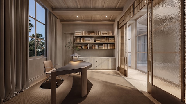 office area featuring beamed ceiling, wood ceiling, light carpet, and built in features