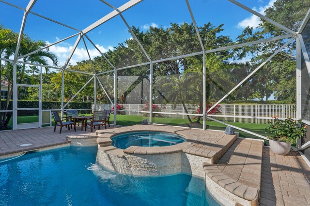 view of swimming pool with an in ground hot tub, glass enclosure, and a patio