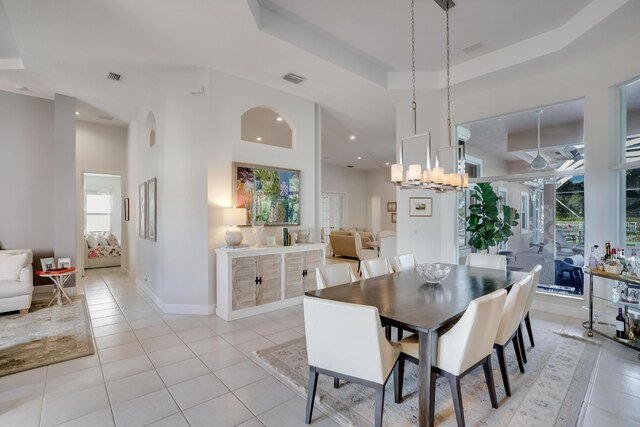 kitchen with dark stone countertops, white cabinets, decorative backsplash, light tile patterned floors, and stainless steel appliances