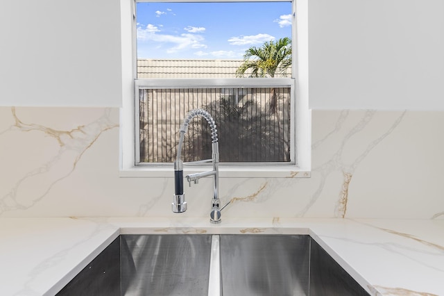 interior details featuring sink and light stone counters