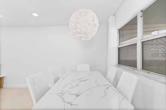 tiled dining area featuring a notable chandelier