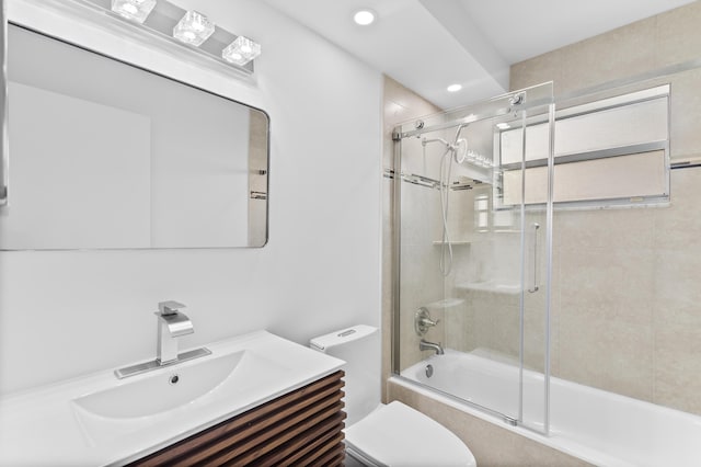 full bathroom with vanity, enclosed tub / shower combo, and toilet