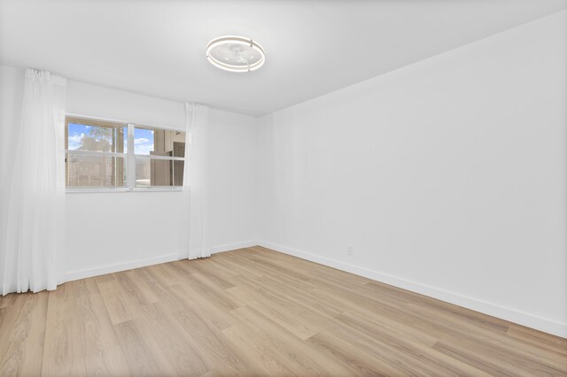 spare room with light hardwood / wood-style floors