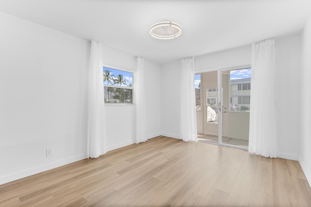 unfurnished room with light hardwood / wood-style floors