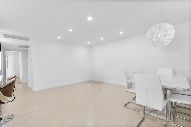 tiled dining space with a notable chandelier