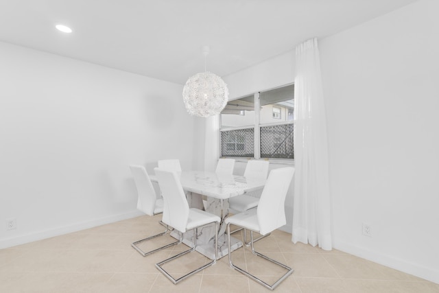 dining room with a chandelier and light tile patterned floors