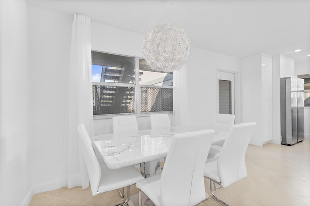 dining room featuring light tile patterned floors and a notable chandelier