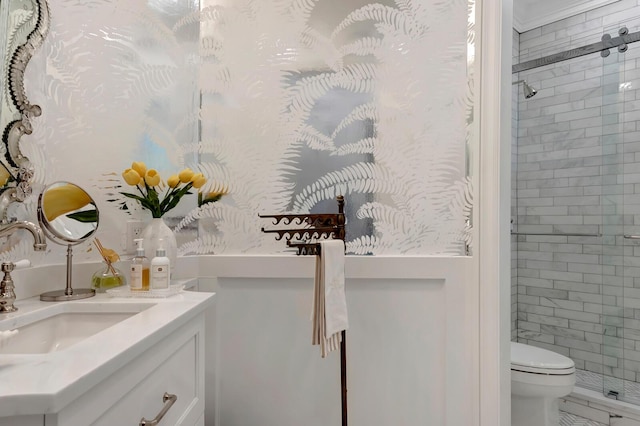 bathroom featuring vanity, a shower with shower door, and toilet