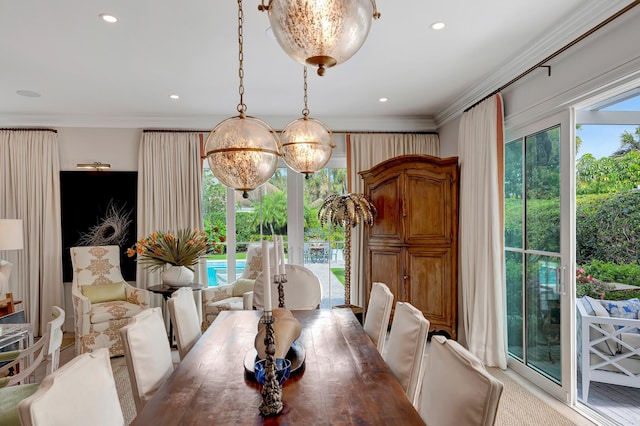 dining area with an inviting chandelier, plenty of natural light, and ornamental molding