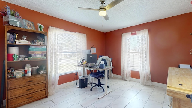 home office featuring ceiling fan and a textured ceiling