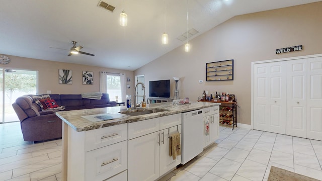 kitchen featuring sink, white cabinetry, a kitchen island with sink, white dishwasher, and light stone countertops