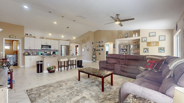 tiled living room featuring vaulted ceiling and ceiling fan