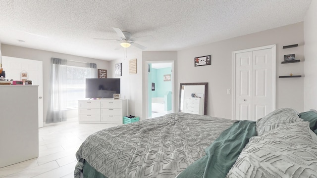 bedroom with a textured ceiling, a closet, and ceiling fan