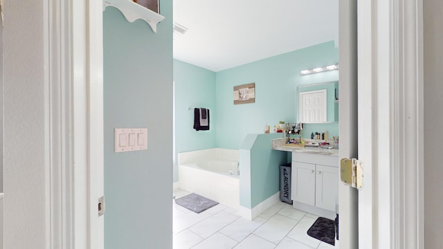 bathroom featuring tile patterned floors, vanity, and a bathing tub