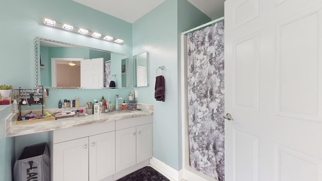 bathroom featuring a shower with curtain and vanity