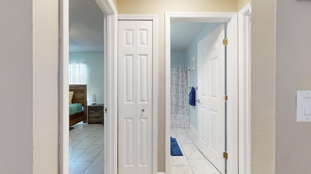 hallway with light tile patterned floors