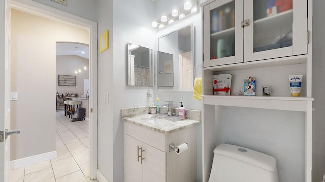 bathroom featuring tile patterned flooring, vanity, and toilet