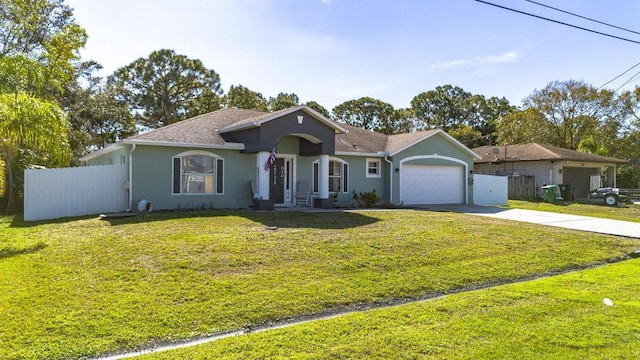 single story home featuring a garage and a front yard