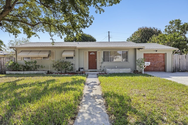 ranch-style house with a garage and a front yard