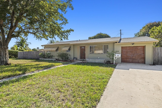 ranch-style home featuring a garage and a front yard