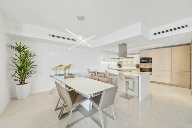 dining room with a chandelier and recessed lighting