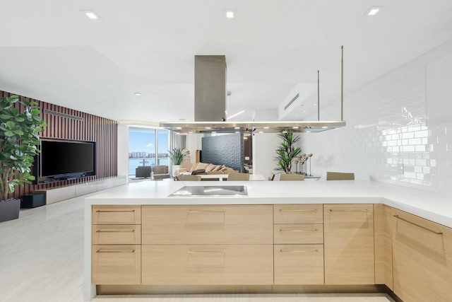 kitchen with modern cabinets, open floor plan, light brown cabinets, and light countertops