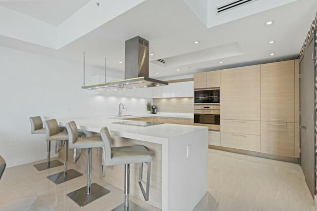 kitchen with a kitchen bar, black appliances, modern cabinets, a sink, and island range hood