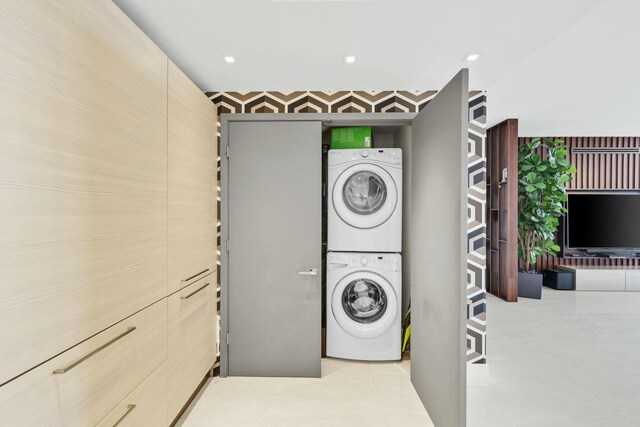 kitchen with stainless steel oven, a tray ceiling, light brown cabinetry, and black microwave