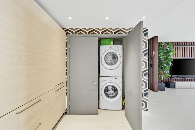laundry area featuring laundry area and stacked washer / drying machine