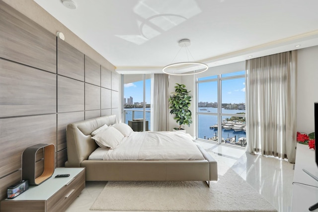 bedroom with a wall of windows and a water view