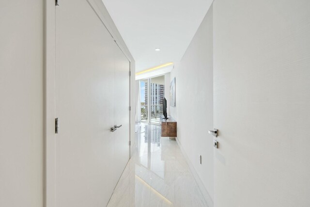 bedroom featuring access to outside and a wall of windows