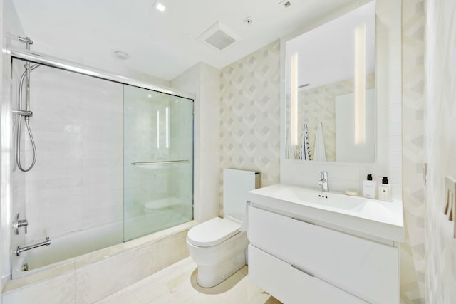 bathroom with vanity, visible vents, enclosed tub / shower combo, wallpapered walls, and toilet
