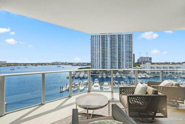 balcony featuring a city view and a water view