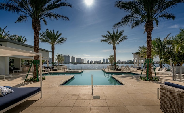 pool with a patio area and a view of city