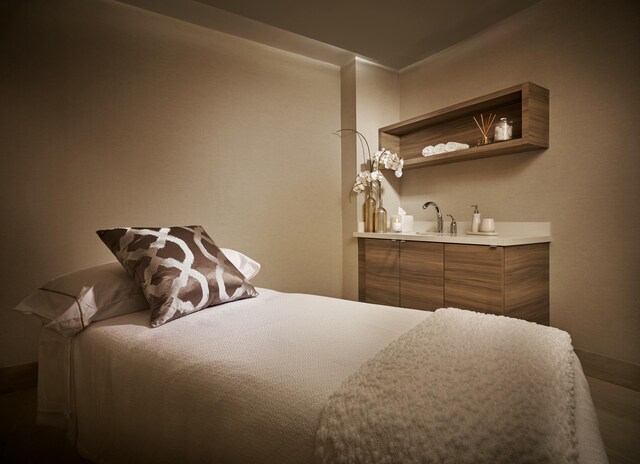 bathroom with wood-type flooring and dual sinks