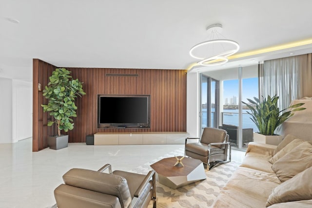 living room with a wall of windows and wood walls