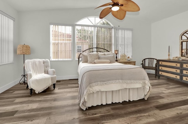 bedroom with ceiling fan, dark hardwood / wood-style flooring, and vaulted ceiling