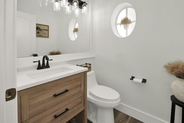 bathroom with vanity, hardwood / wood-style flooring, and toilet