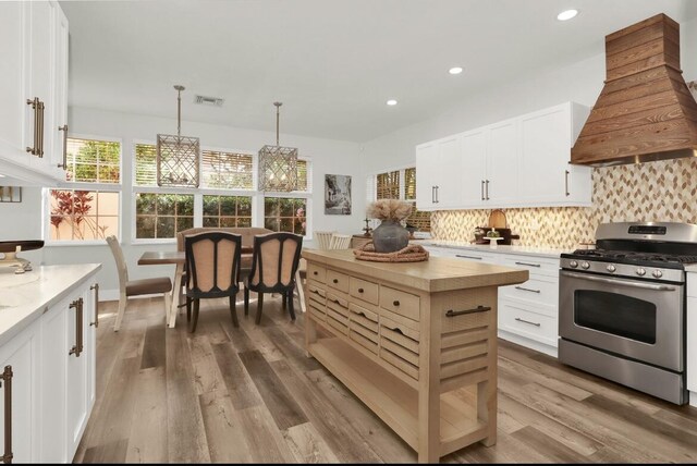 kitchen featuring white cabinetry, stainless steel appliances, dark hardwood / wood-style floors, and custom exhaust hood