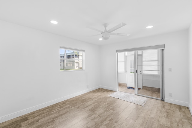 empty room with a ceiling fan, recessed lighting, baseboards, and wood finished floors