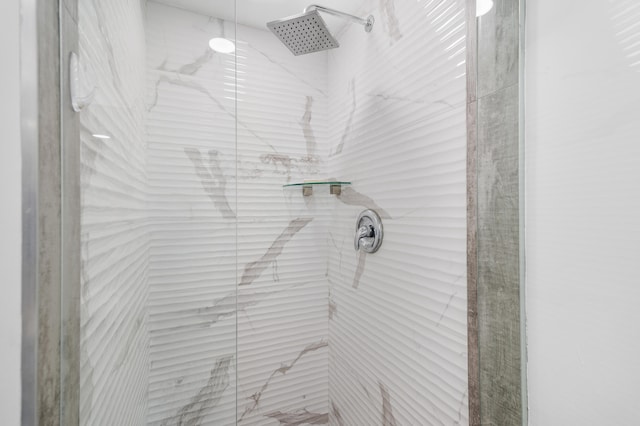 room details featuring a marble finish shower