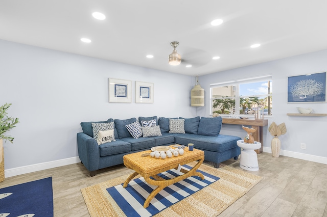 living room featuring light wood-style floors, recessed lighting, and baseboards