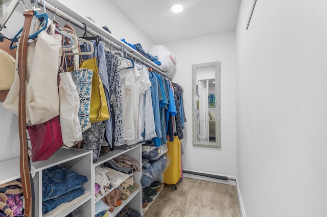 walk in closet with hardwood / wood-style flooring